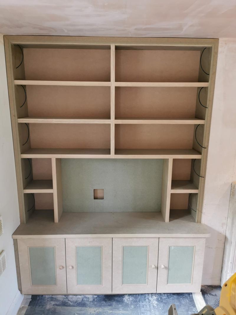 Bespoke dresser unit newly built and primed, with open shelving above glazed cupboards