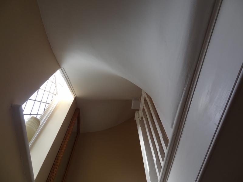 Curved plastered ceiling over the stairwell, following the line of the new roof
