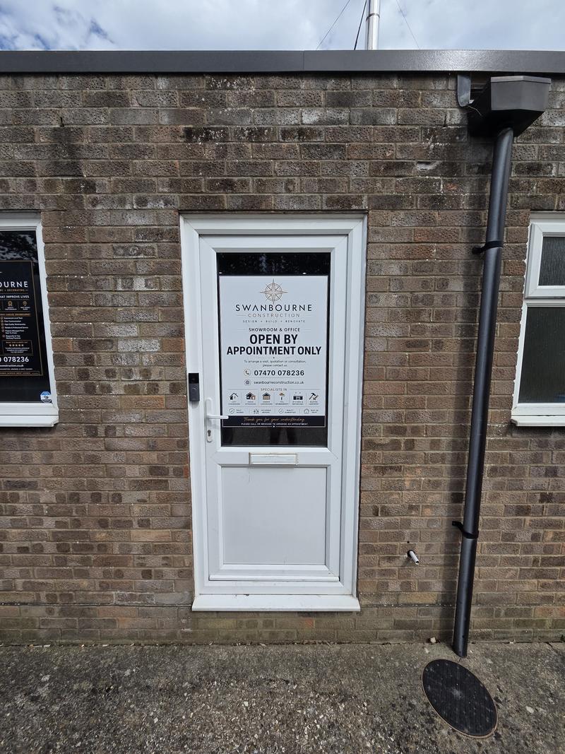 Entrance door to the showroom and office with a notice reading Open By Appointment Only