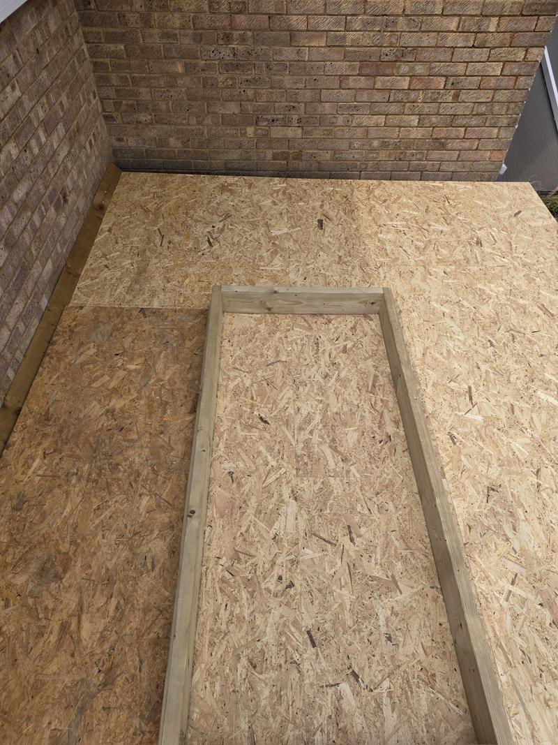 Flat roof boarded out in sterling board with a timber kerb framed up ready for a roof lantern