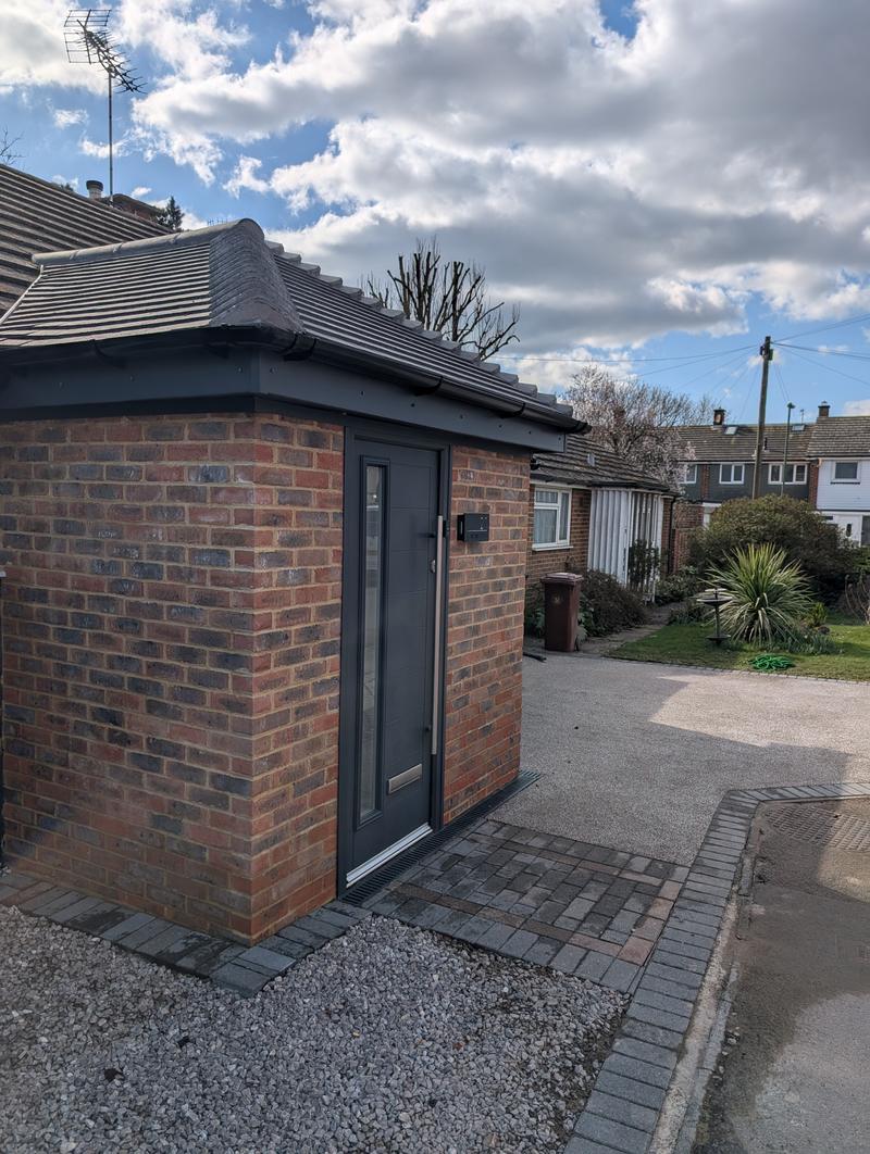 New brick porch and block-paved path leading to a resin-bound driveway