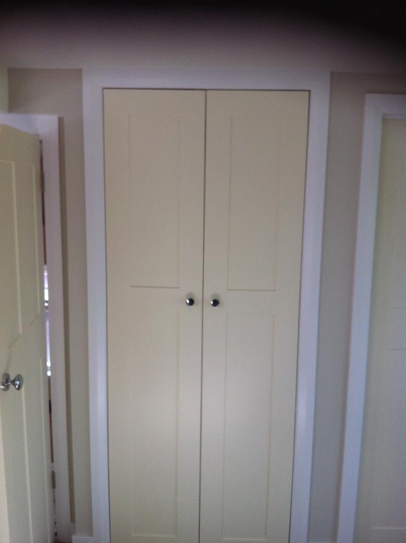 Pair of hand-built painted wardrobe doors with a shaker panel and chrome knobs