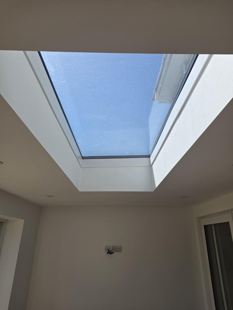 Roof lantern seen from directly below, set into a white plastered ceiling