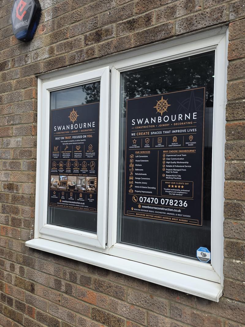 Showroom window graphics listing the services Swanbourne Construction offers