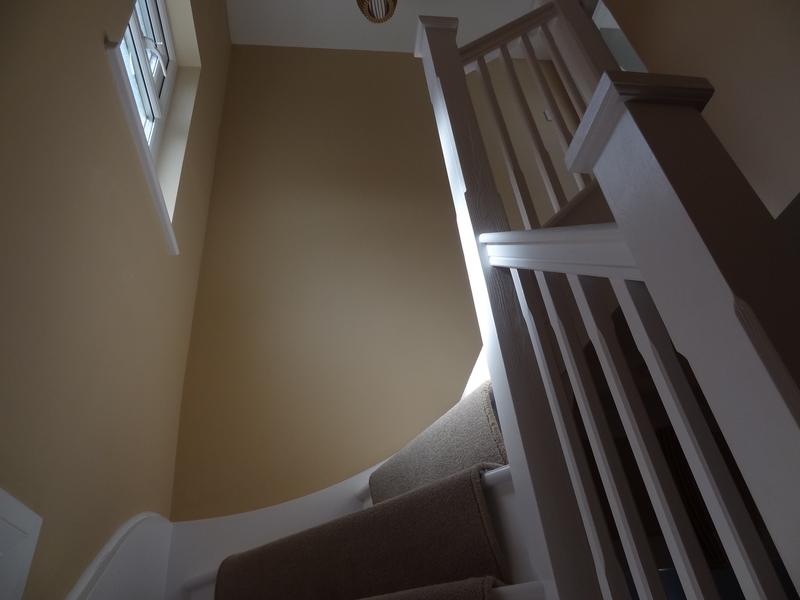 Staircase and painted balustrade seen from the landing below