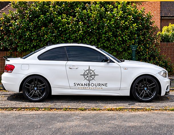 Swanbourne Construction company car, a white BMW coupe with the compass mark and company name on the door
